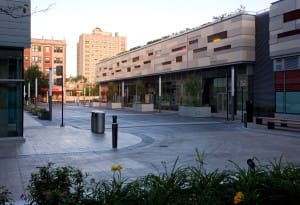 Click to enlarge The internal street in Harper Court as it turns toward South Harper Avenue. Storefronts in this area are devoted to restaurants and other food services. Structured parking is on the second level, with open-air parking on the third level. Credit: Leslie Schwartz Architectural Photography